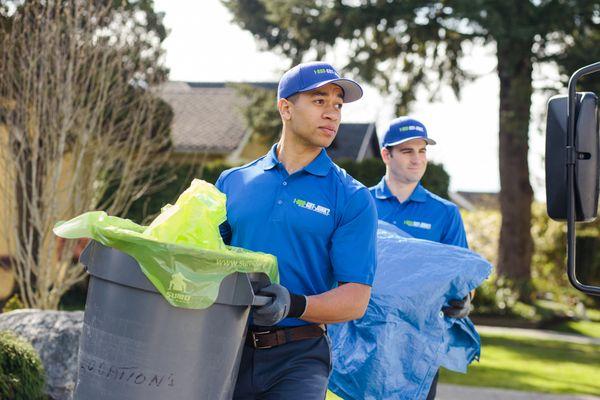 1-800-GOT-JUNK? Truck Team carrying trash cans