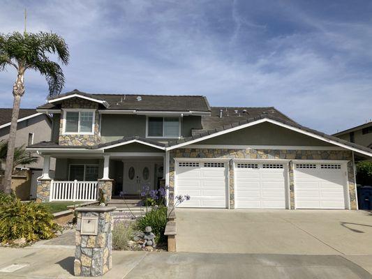 Our home showing a lot of the trim, fascia, front door, and garage doors that were painted along with all the stucco.