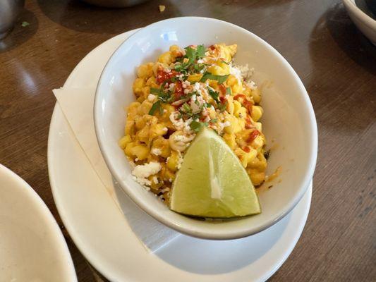 Street Style Corn - creamy sweet corn, sour cream, cotija, Tajin