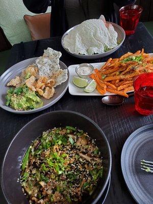 Clockwise: tuna tostsda bowl, sweet potatoe fries, udon, guac