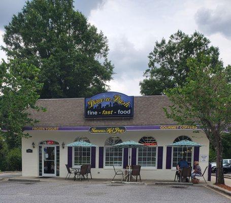 Front of restaurant with tables/umbrellas