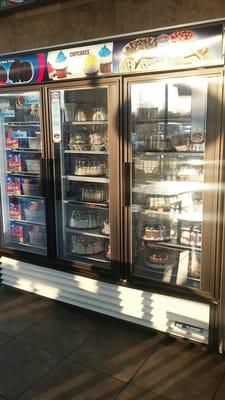 Refrigerated dessert case with ice cream bars, ice cream cakes and fudgesicles.