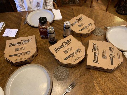 The dinner spread, four to-go personal pan pizzas.