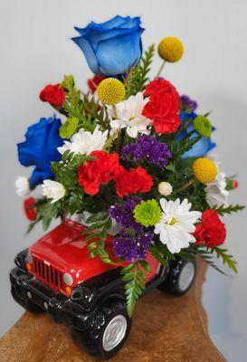 Blue Roses and mix Flowers in a RED JEEP