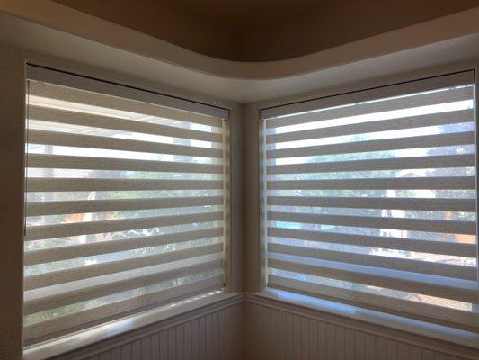 Designer banded shades by Hunter Douglas with soft touch motorization in a bathroom.