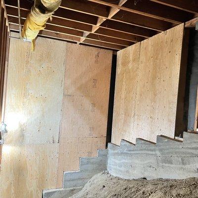 Stair step foundation and shear wall