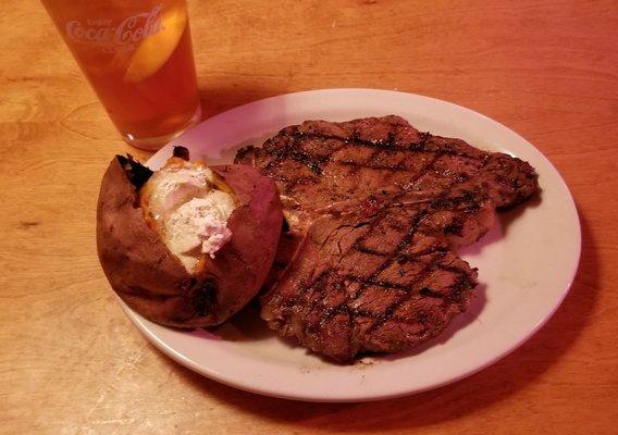 Texas Roadhouse in Racine, Wisconsin. 23 ounce Porterhouse with baked sweet potato. Awesome!