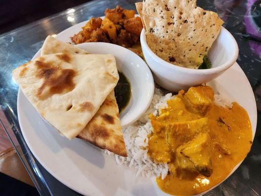 Yummy foods from buffet - chicken tikka, papad, naan, dal, rice