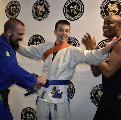 Lawson reaching his blue belt from Anthony Mitchell with Anderson Silva