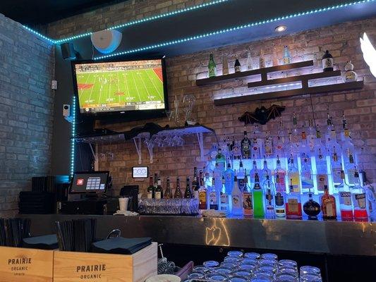 Bar with tv showing college football