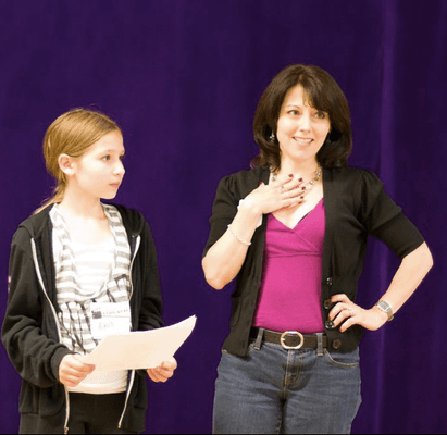 Caroline Daly Antonelli works with a student on the importance of stage presence