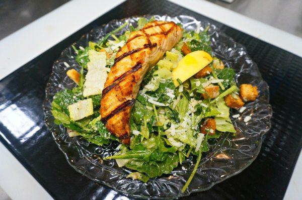 Grilled Wild Salmon - served on a bed of seasoned lentils with lemony tzatziki drizzle and seasoned micro-greens to p garnish