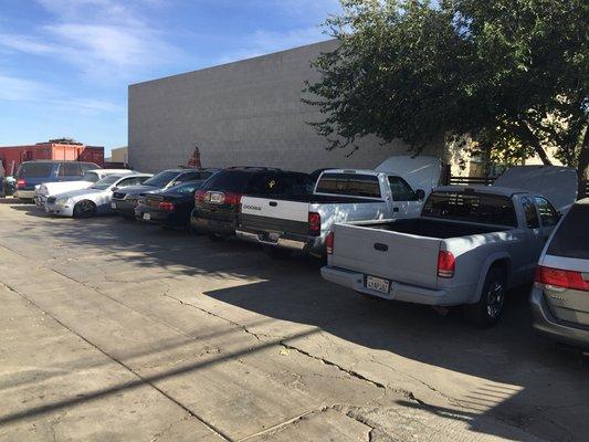 Parking lot full of customers vehicles waiting to be repaired