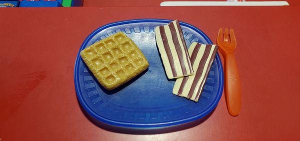 Waffle with two strips of what I think is bacon