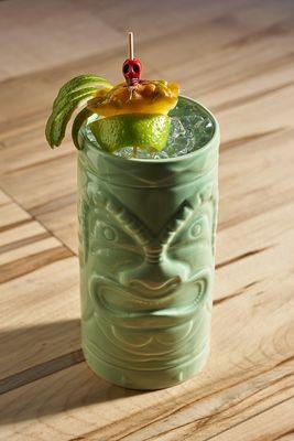 A specialty cocktail in a tiki mug