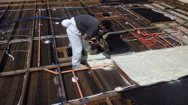 Closed Cell Polyurethane Spray Foam applied on the roof. This is a flat roof, plywood going on next.  Closed Cell SPF is a vapor