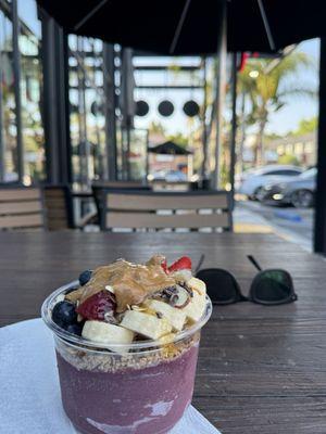 Açaí bowl topped with creamy peanut butter and honey. So yum