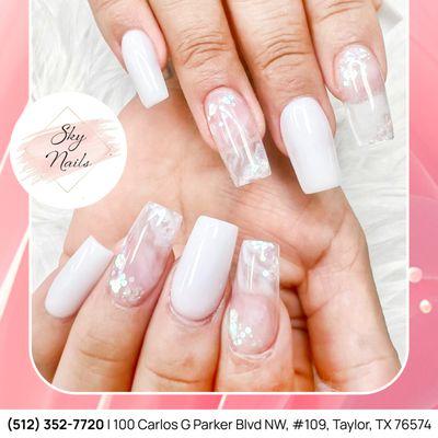 A perfect blend of elegance and creativity--white nails paired with transparent accents and delicate white designs