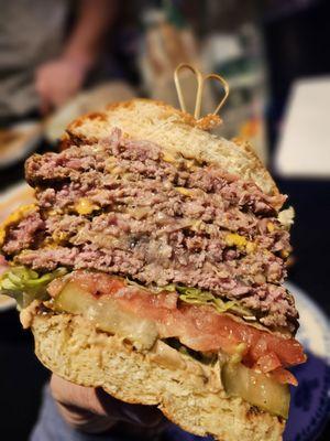 The animal burger 4x4 cut in half