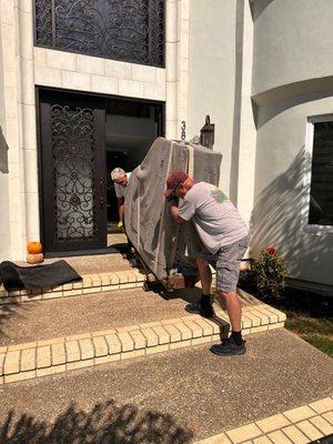 Carefully moving the piano into the new house