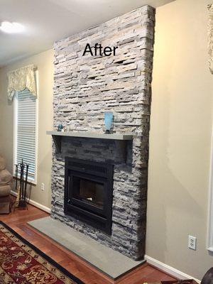 After- new high efficiency wood burning fireplace and stone facade.