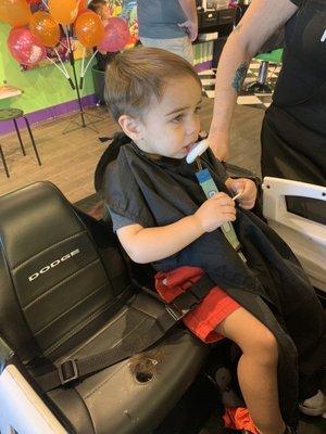 Before photo of my son In a cop car chair