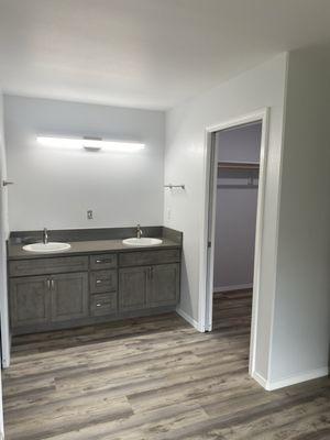 Double sinks with vanity cabinet at master bedroom