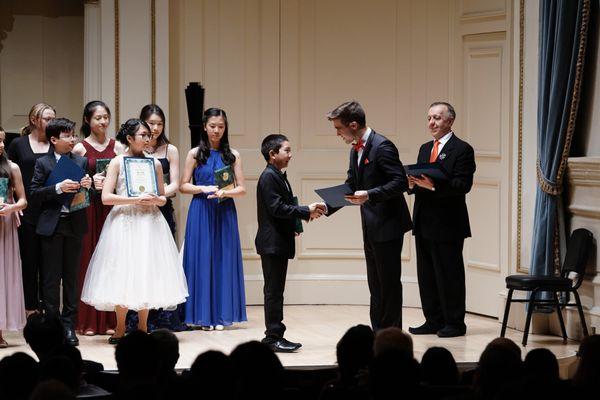 Wyatt being awarded at Weill Recital Hall at Carnegie Hall in New York City as a winner of  American Protégé International Competition