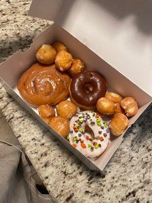 Donut holes, M&M donut, chocolate frosted, and cinnamon bun donut