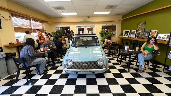 Interior of the cafe with out 1989 Nissan Pao on display.