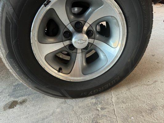 New tire with new plastic lug nuts.