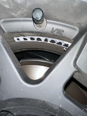 Adhesive left on rim.