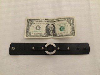 Length in comparison to a dollar bill. This bracelet was big enough to fit my muscular wrist.