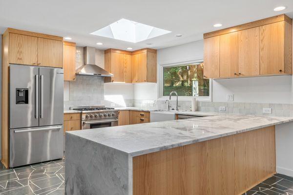 Gale Hybrid stone countertops with farmhouse sink.