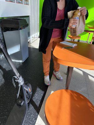 Owner gifting two doughnuts and an orange juice