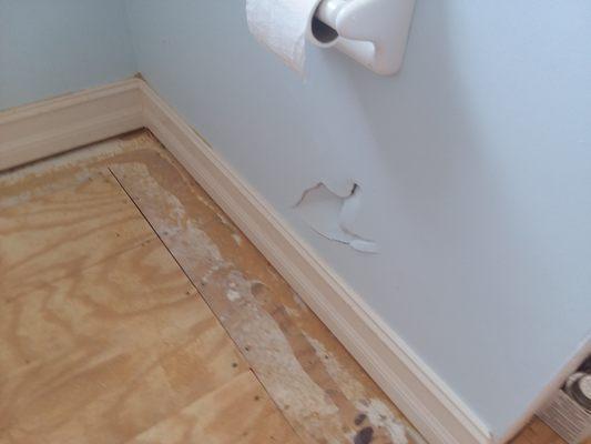 Hole punched in wall by flooring installer.