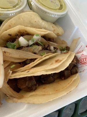 Three tacos with corn tortillas.