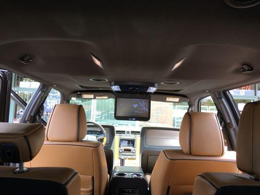 Lincoln Navigator overhead monitor w/dvd installation by Chavez Electronics.