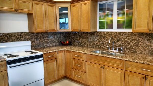 Backplash is not a good choice with these cabinets.  The stove is beyond basic and just out of place.  Top corner cabinet doesn't match.