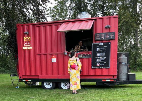 Look for the red shipping container food cart for deliciousness!