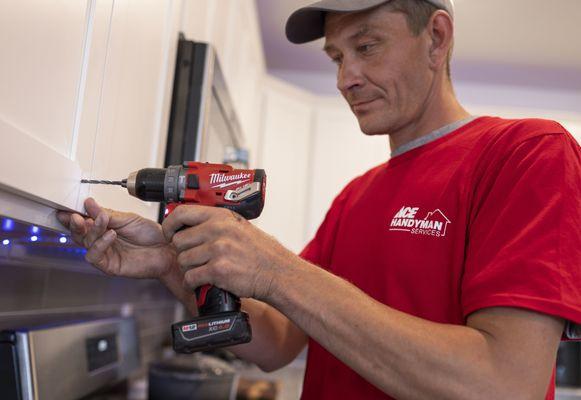 Ace Handyman Services Redwood City installing cabinets in kitchen remodel