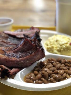 Ribs on top of brisket with beans and potato salad.