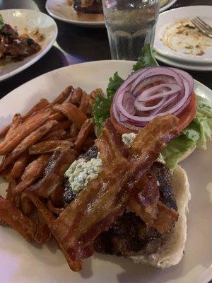 Burger with bacon and blue cheese crumbles and onion and sweet potato fries