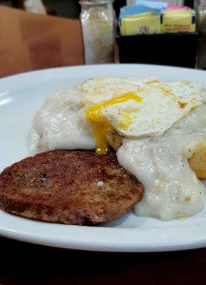 Sausage gravy and biscuit with egg and sausage patty