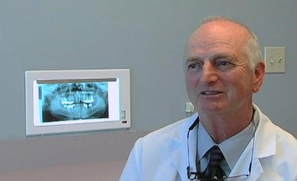 Orthodontist Dr. Steven Reeves explaining various options with patient