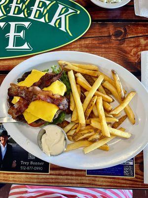 The Texan 1/2 lb Burger with bacon, cheese, pickles, tomatoes, onion and lettuce.