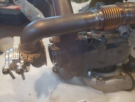 BEFORE    Dump tube too tall for new turbo manifold, wastegate not seated properly