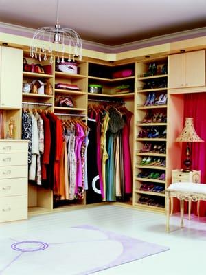 Walk in Closet with slanted shoe rails, custom vanity and a mixture of shelves & drawers