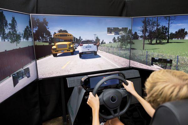 New driver navigating local roads in the Greenlight driving simulator.