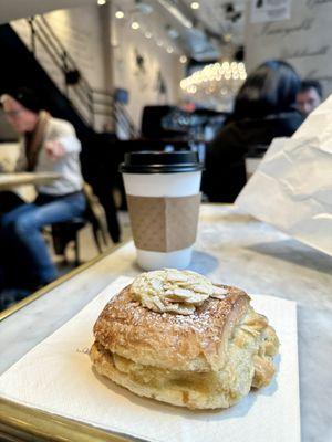 Chocolate almond croissant and a cappuccino.